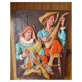 This vintage mid-century modern 3D wall sculpture, titled "Jesters and Clowns" or "Renaissance Minstrels," is a fiberglass art piece by the artist J. Segura