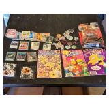 Various Collectibles and Trading Cards including Power Rangers Mystic Cycle Blasters, The Simpsons Comics, and PokÃ©mon Cards