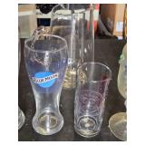 Variety of Glassware and Pitcher Collection Including Bubba Gump and Blue Moon Glasses