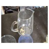 Variety of Glassware and Pitcher Collection Including Bubba Gump and Blue Moon Glasses