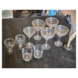 Various Glasses, Some Plastic and Goblets Including Skeleton Hand Stand and Bullet Embedded Tumblers