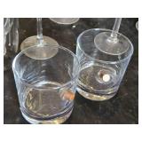 Various Glasses, Some Plastic and Goblets Including Skeleton Hand Stand and Bullet Embedded Tumblers