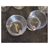 Various Glasses, Some Plastic and Goblets Including Skeleton Hand Stand and Bullet Embedded Tumblers