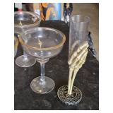 Various Glasses, Some Plastic and Goblets Including Skeleton Hand Stand and Bullet Embedded Tumblers