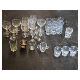 Set of Assorted Glassware Including Shot Glasses, Wine Glasses, and Novelty Glasses