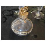 Mixed glassware including Stella Artois glasses, wine glasses with green stems, and a decorative bottle with a crown top.