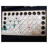 Loose gemstones collection in display case including various cuts and colors