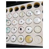 Loose gemstones collection in display case including various cuts and colors