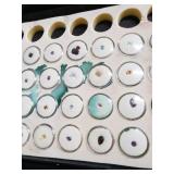 Loose gemstones collection in display case including various cuts and colors
