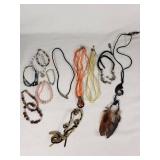 Lot of Jewelry Including Feather Necklace, Beaded Bracelets, and Decorative Pendants