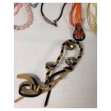 Lot of Jewelry Including Feather Necklace, Beaded Bracelets, and Decorative Pendants