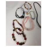 Lot of Jewelry Including Feather Necklace, Beaded Bracelets, and Decorative Pendants