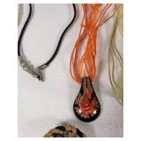 Lot of Jewelry Including Feather Necklace, Beaded Bracelets, and Decorative Pendants
