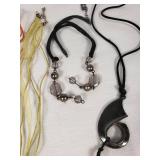 Lot of Jewelry Including Feather Necklace, Beaded Bracelets, and Decorative Pendants