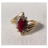 Gold Ring with Marquise-Cut Red Gemstone and Accent Stones The band is marked with "10K," indicating 10 karat gold