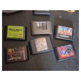 Assorted Video Games, Console, and Accessories Lot including VR Real Feel Racing, Game Boy Advance, and Sega Genesis Cartridges