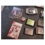 Assorted Video Games, Console, and Accessories Lot including VR Real Feel Racing, Game Boy Advance, and Sega Genesis Cartridges