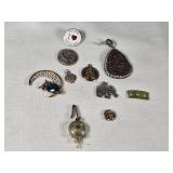 Assorted Jewelry and Pins including Brooches, Medallions, and Charms