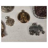 Assorted Jewelry and Pins including Brooches, Medallions, and Charms