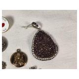 Assorted Jewelry and Pins including Brooches, Medallions, and Charms