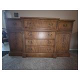 Wooden credenza featuring ornate brass hardware