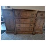 Wooden credenza featuring ornate brass hardware