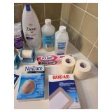Assortment of bathroom essentials - unopened soap, eye drops, bandages, vintage razor, Witch Hazel, and more