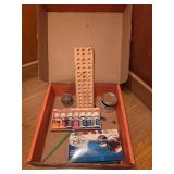 Box of art supplies including paint