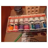 Box of art supplies including paint