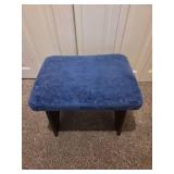 Vintage wooden footrest with blue cushioned top