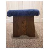 Vintage wooden footrest with blue cushioned top