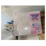 Bin of scrapbook/album sheets, tape and supplies