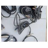 Assortment of xlr, 3.5, 1/4" audio cables and adapters.