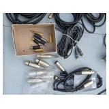 Assortment of xlr, 3.5, 1/4" audio cables and adapters.