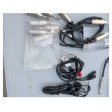 Assortment of xlr, 3.5, 1/4" audio cables and adapters.