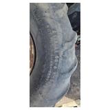 Three Carlisle Tractor Tires on Rusted Rims