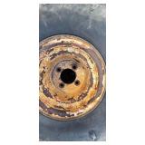 Three Carlisle Tractor Tires on Rusted Rims