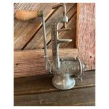 Cast iron hand-crank meat grinder.