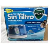NEW in box Vicks Filter-Free Cool Mist Humidifier. Low maintenance, no filters to replace! Large 1-gallon tank runs 18-24 hours. Features a VapoPad heater for soothing menthol scent. Perfect for mediu