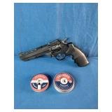 Crosman Vigilante CO2 revolver air pistol accompanied by two tins of .177 caliber Premier pellets.