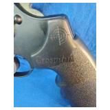Crosman Vigilante CO2 revolver air pistol accompanied by two tins of .177 caliber Premier pellets.