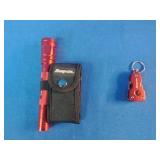 Snap-on brand red multi-tools and a matching flashlight.