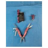Snap-on brand red multi-tools and a matching flashlight.