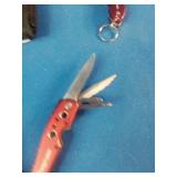 Snap-on brand red multi-tools and a matching flashlight.