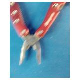 Snap-on brand red multi-tools and a matching flashlight.