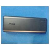 Anker PowerCore 20100mAh portable charger in black, Black Simmons 8x21mm SCL Model 1156 compact binoculars, and Book light featuring the Nikon logo