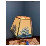 Vintage nautical-themed table lamp with doily