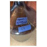 Glass gallon jug with pennies.