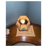 Vintage nautical-themed table lamp with doily