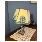 Vintage nautical-themed table lamp with doily